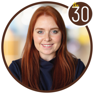 Kaitlyn Watkins Quezada with red hair and a nice smile