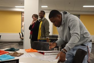 Students examine 3D-printed models of Mount Etna before using the VR application.