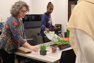 Student add Seed Library workshop with University Libraries' Associate Dean Mary O'Kelly.