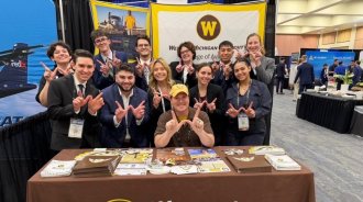 Group of WMU students at a table for the NGPA spring expo.