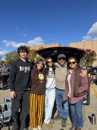 Family standing together at WMU tailgate.