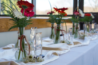 A row of glass award trophys on a table draped with flowing white fabric, set for the award ceremony.