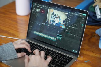 Julia Adams edits a video clip to post on social media.