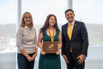 At the Presidential Scholars 2026 celebration are, left to right, Adrienne Redding, English honoree Janine Adamski , and President Russ Kavalhuna. 