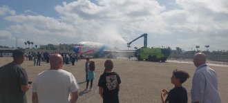 Sharmain Moulton hosting an Aviation Career Exploration Camp - picture of an ARF Firetruck demonstration as it sprays an aircraft with water 