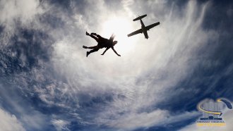 student jumping out of plane.