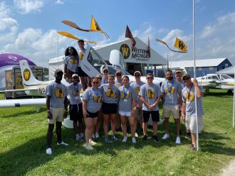 A group of students at a flight event in Oshkosh, Wisconsin.