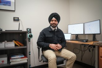 Arshpreet Singh works at a computer in his office.