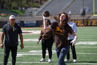 Brody Bender throws a football.