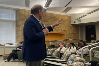Former Detroit Mayor, Mike Duggan, guest speaks for a School of Social Work class.
