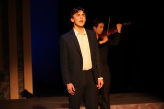 Jack Austin sings on stage.