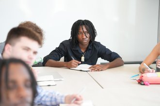 Ja'Don Brown-Warren takes notes in Management 2020