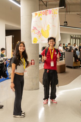 Students hold a sign depicting their family name for the MAASU Spring Conference.