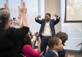 Samuel Marseille raises his arms in celebration after winning the Cultivate 269 grand prize.