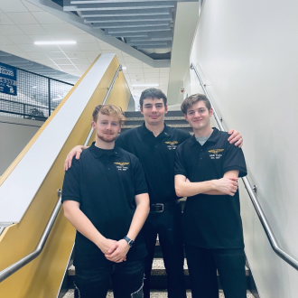 Students standing on College of Aviation staircase.