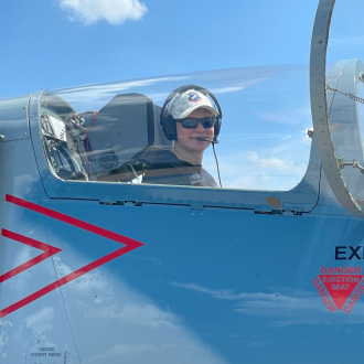 Student inside fight jet flight deck.