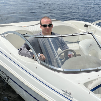 Student driving speedboat.