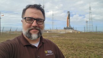 WMU CoA alumni Dan Kosters with Artemis II in the background