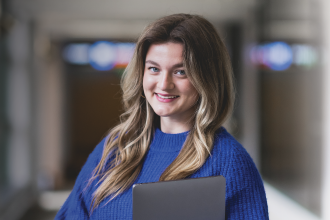 Madison Petroff in the hallway holding her computer