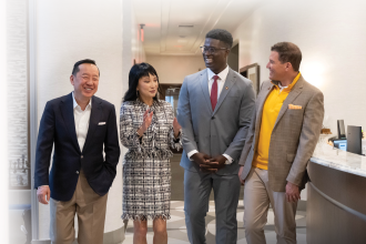 Mo Tall standing with the Zhangs and President Kavalhuna