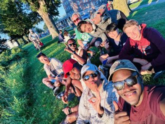 An international student and his friends pose for a picture on campus.