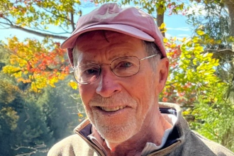David Sluyter wearing a light shirt and red baseball cap