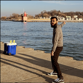 An international student poses near Lake Michigan during his time at WMU.