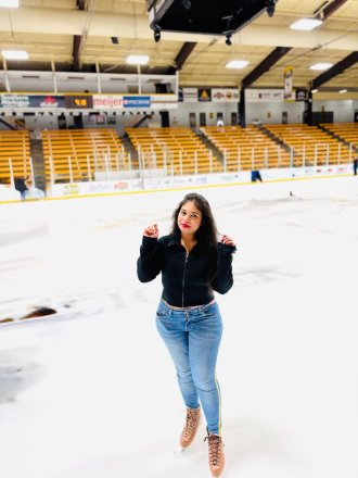 An international student from India poses at the ice arena.