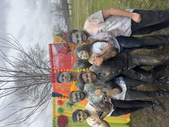 An international student poses with his friends at Holi, a campus event hosted by the Indian Student Association and the Haenicke Institute for Global Education.