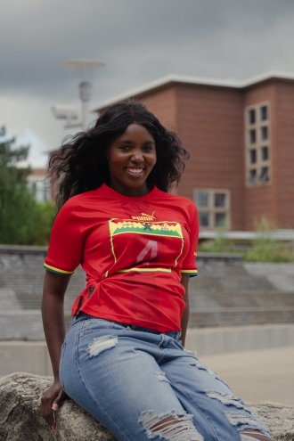 An international student poses on campus.