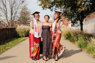 An international student from Indonesia poses during graduation season with her friends.