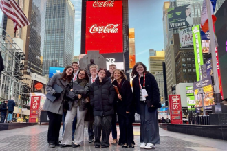 A group of students stands in Times Square in New York City.