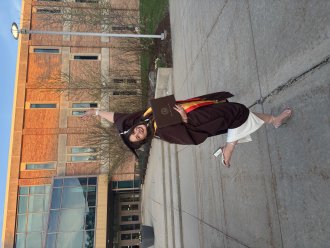 An international student poses during graduation season.