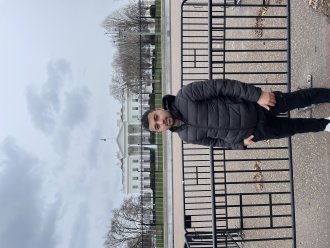 An international student poses by a Washington, D.C., monument.