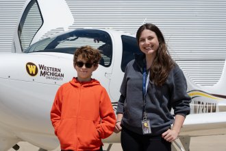 Vail Fear and Grace Blackburn stand in front of a Cirrus G7 aircraft at WMU's College of Aviation.