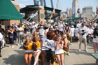 Buster Bronco and the WMU cheer team sit together at Comerica Park