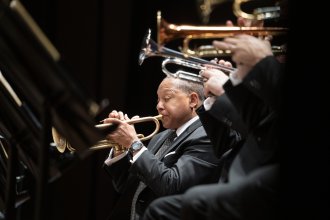 Wynton Marsalis plays the trumpet at a concert.