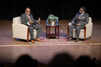 Wynton Marsalis and Millard Southern sit together on a stage during a discussion at Kalamazoo College.