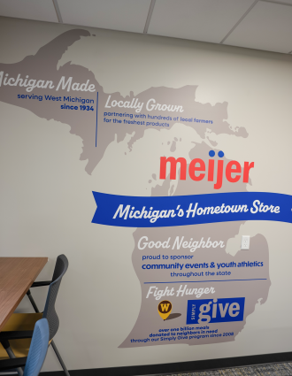 A Meijer wall with a display of the good neighbor typography