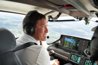 President Russ Kavalhuna flies a plane.