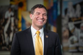 A portrait of President Russ Kavalhuna.