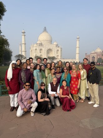 A group of WMU students takes a photo in front of the Taj Mahal.