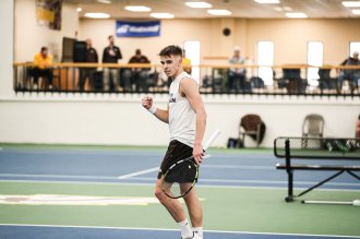 A tennis player walks on the court.