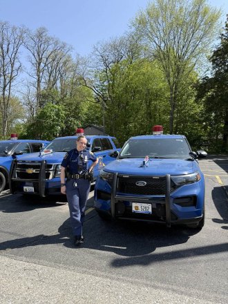 Shelby Wilmot stands next to a patrol car.