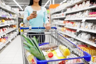 Shopper in grocery store deciding what to buy