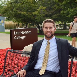 WMU Aviation Alumni Joe Zynda in front of the WMU Lee Honor's College Sign