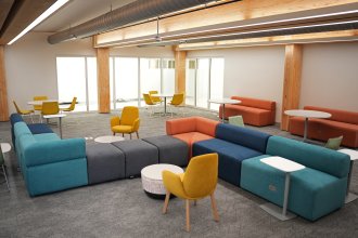 A programming and community space with ample seating inside Valley Oaks.