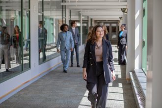 A student walks down the hallway at the Haworth College of Business