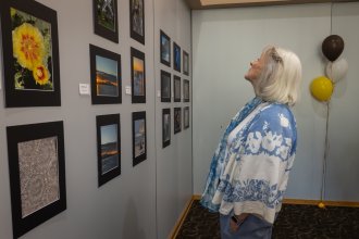 Member Looking at Photography Exhibit