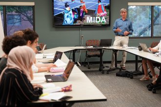 Dr. Paul Clements, Professor of Political Science and Director of the M.I.D.A. Program and C.C.P.M. Graduate Certificate, instructs students in the classroom.